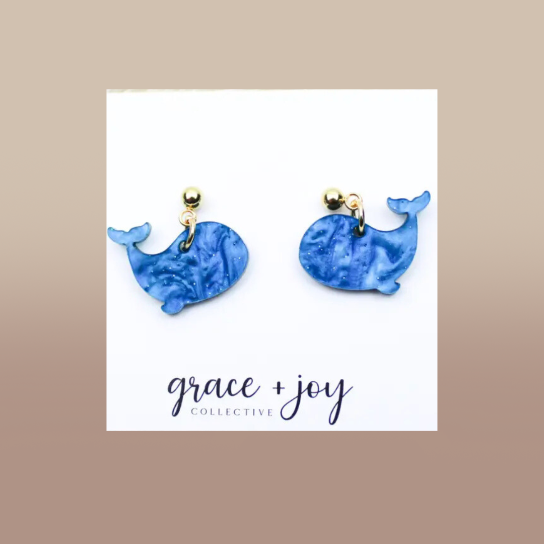 Blue Whale Dangle Earrings in marbled blue acrylic, featuring whale-shaped charms and gold-tone studs.