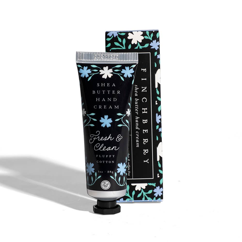 Hand cream tube and box in black with blue and white floral print, featuring the Fresh & Clean Hydrating scent label.