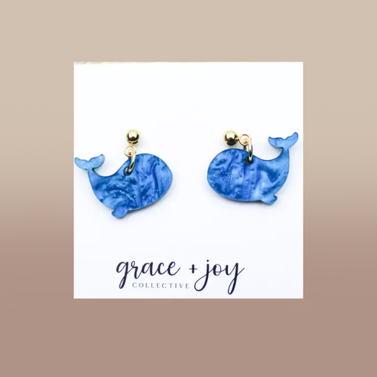 Blue Whale Dangle Earrings in marbled blue acrylic, featuring whale-shaped charms and gold-tone studs.