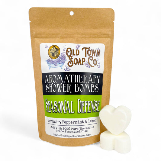 Shower Bombs/Steamers in a brown kraft pouch, with two white heart-shaped tablets and a green Seasonal Defense label.