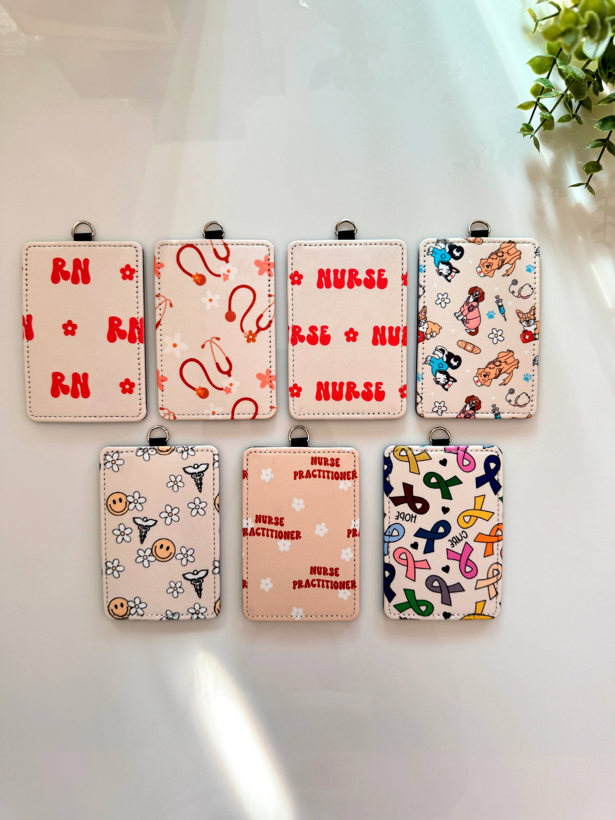 ID Badge Holder Occupation in assorted pastel colors with patterned faux leather, nurse and medical-themed prints, and top clips.